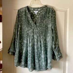 A woman’s blouse, teal color with floral print